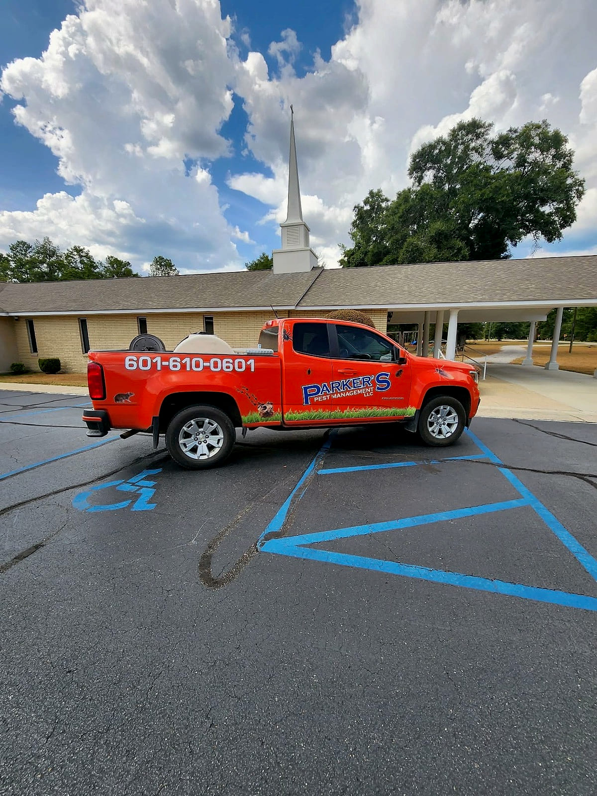 A Parker's Pest Management truck parked at a church